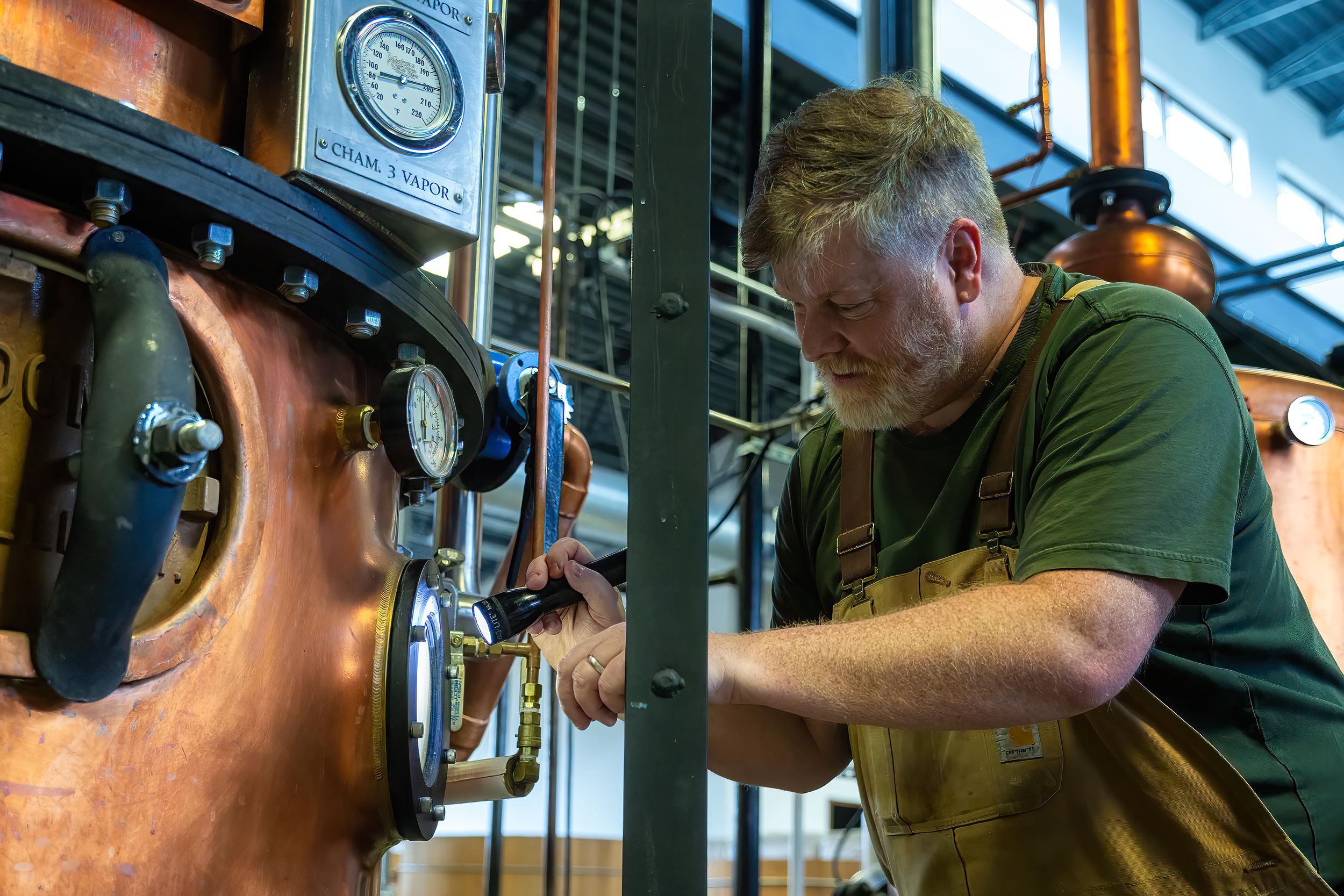Master Distiller of Leopold Whiskey checking progress of whiskey for Distilled Magazine