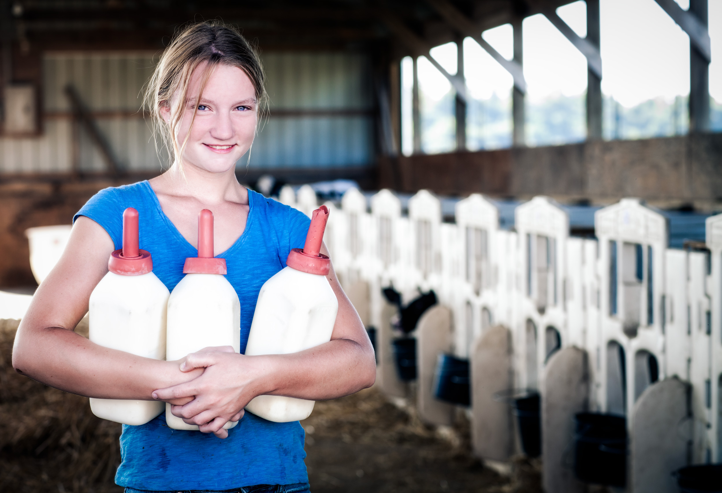 Agriculture Photography young girl with milk bottles for dairy calves