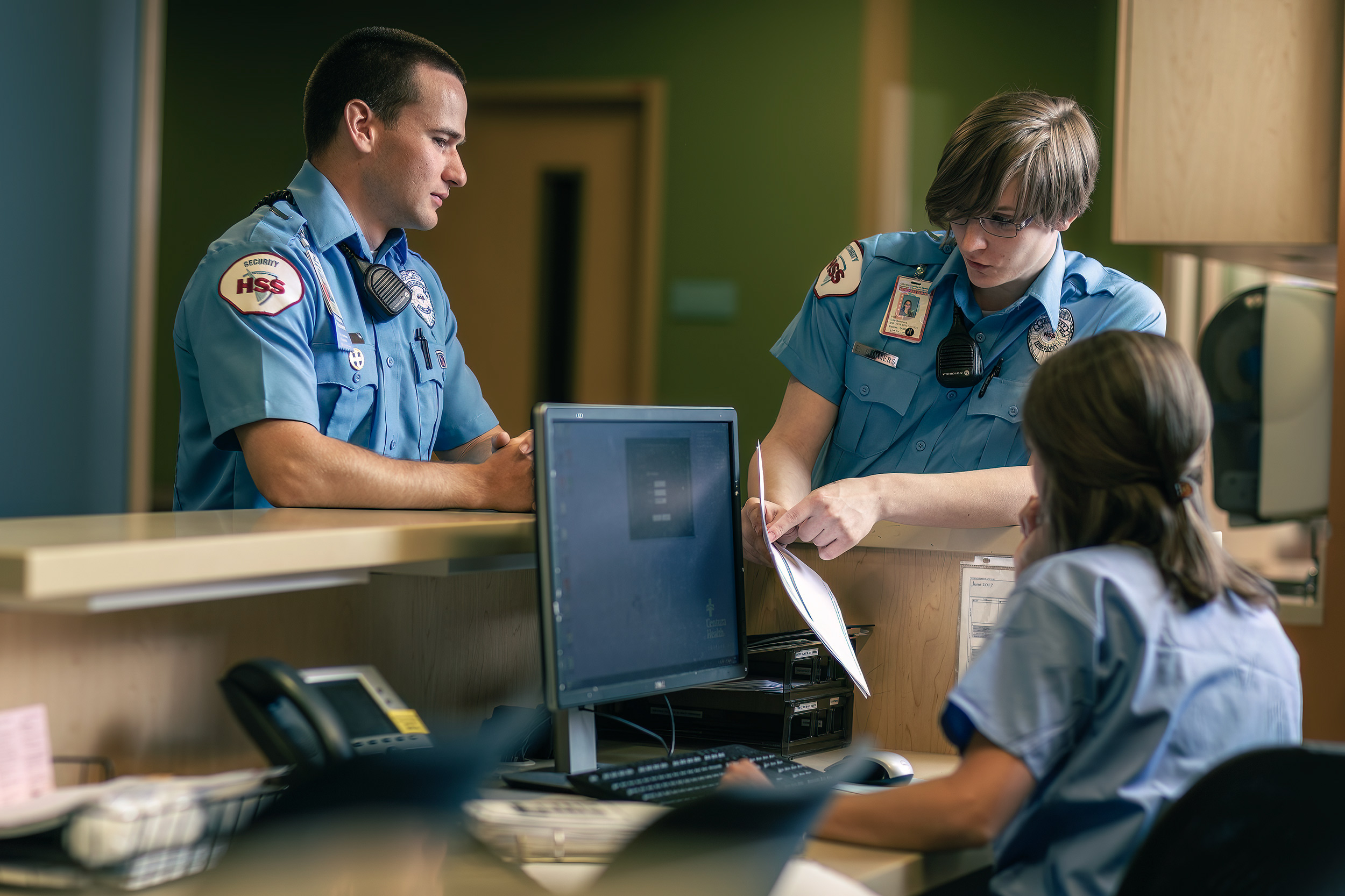 Security Guard checking in with nurse in hospital for HSS advertising. 