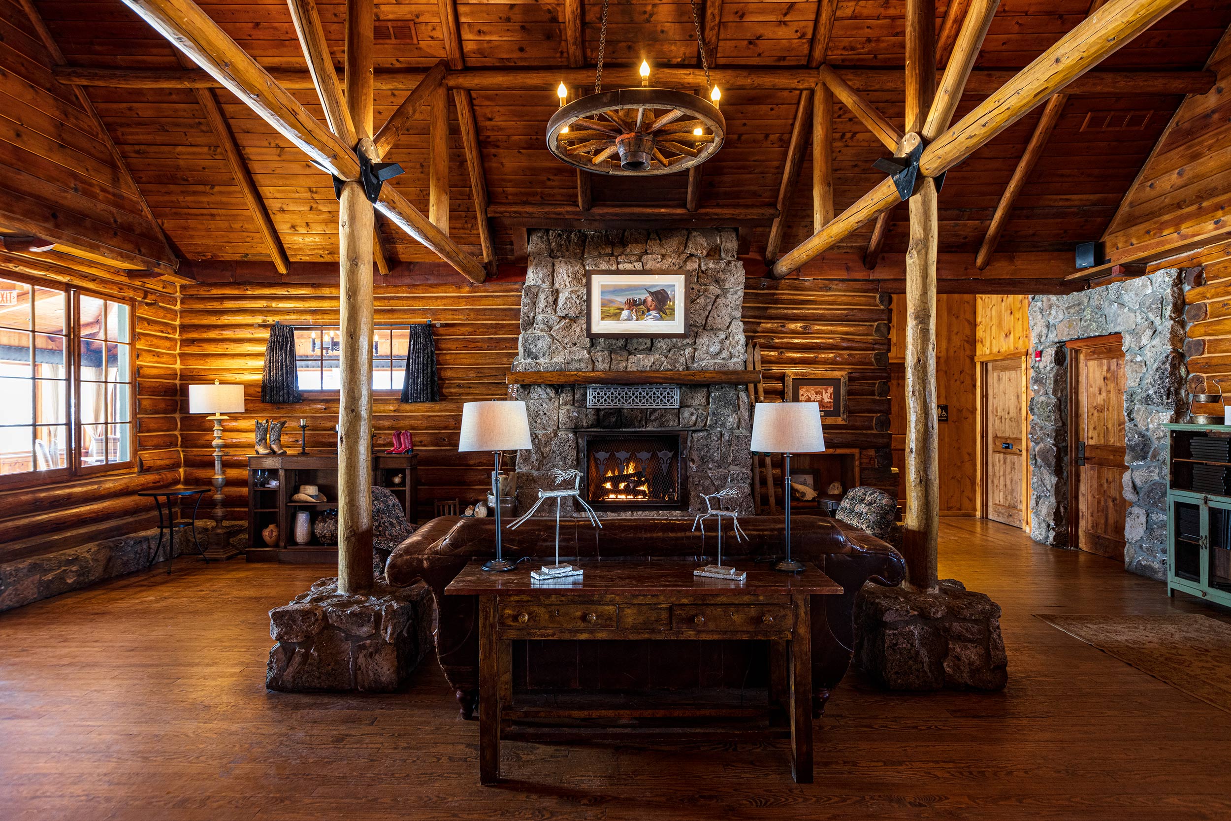 Fireplace and wheel lantern interior in lodge lobby  for Devils Thumb Ranch