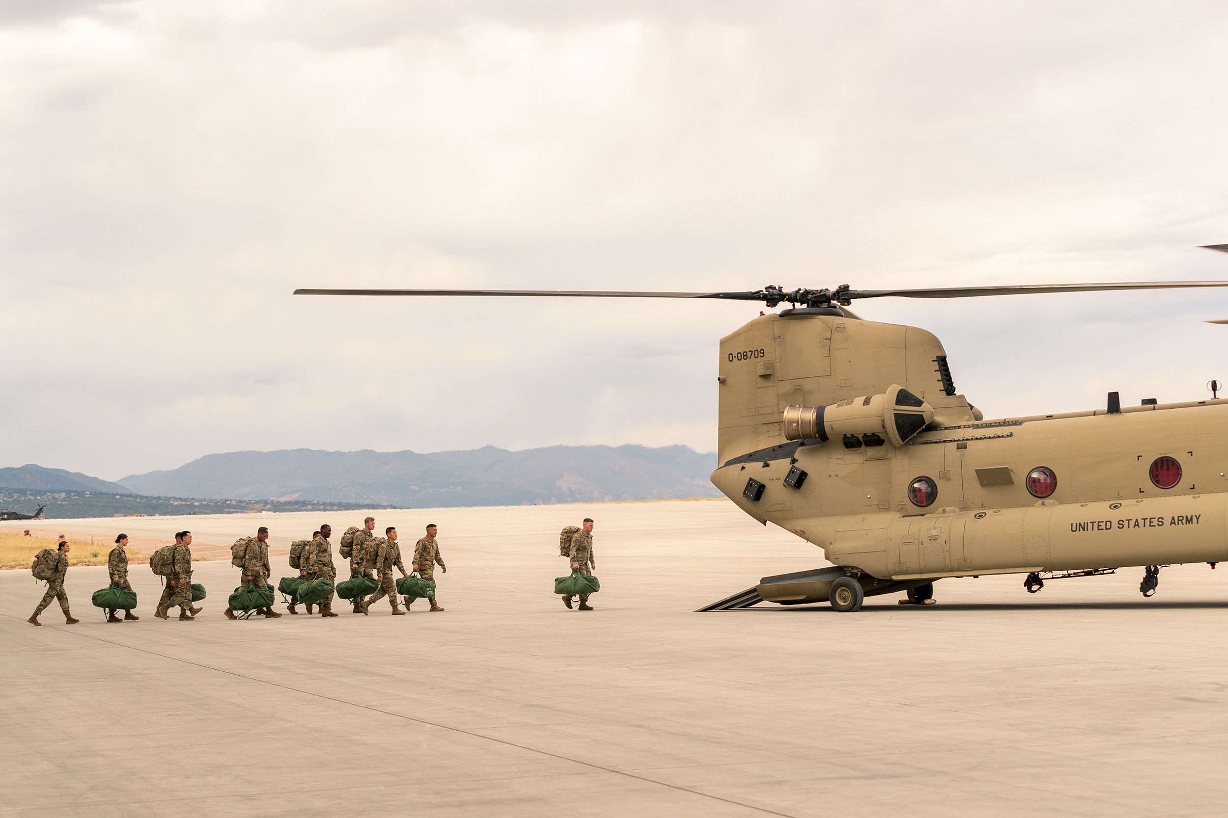 Soldiers loading in Chinook Helicopter on Army Base US Army Advertising