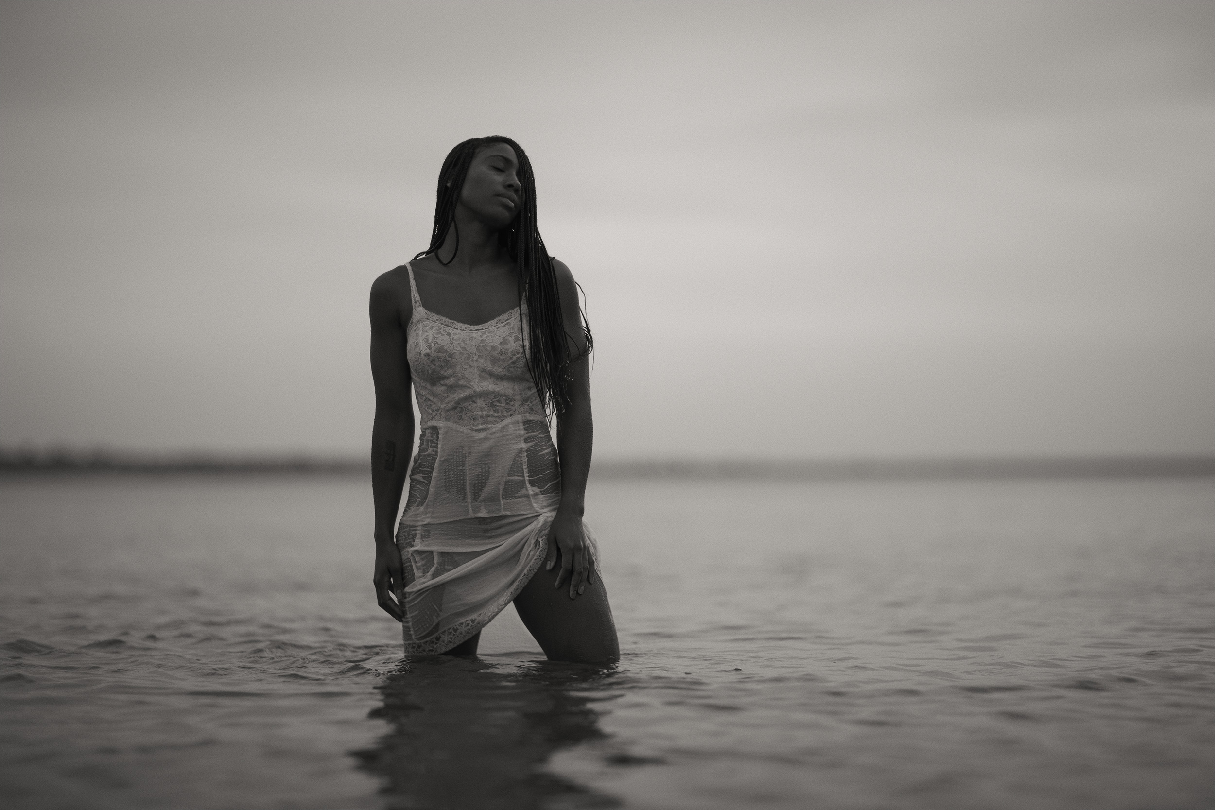Black and white photo of a woman in lake