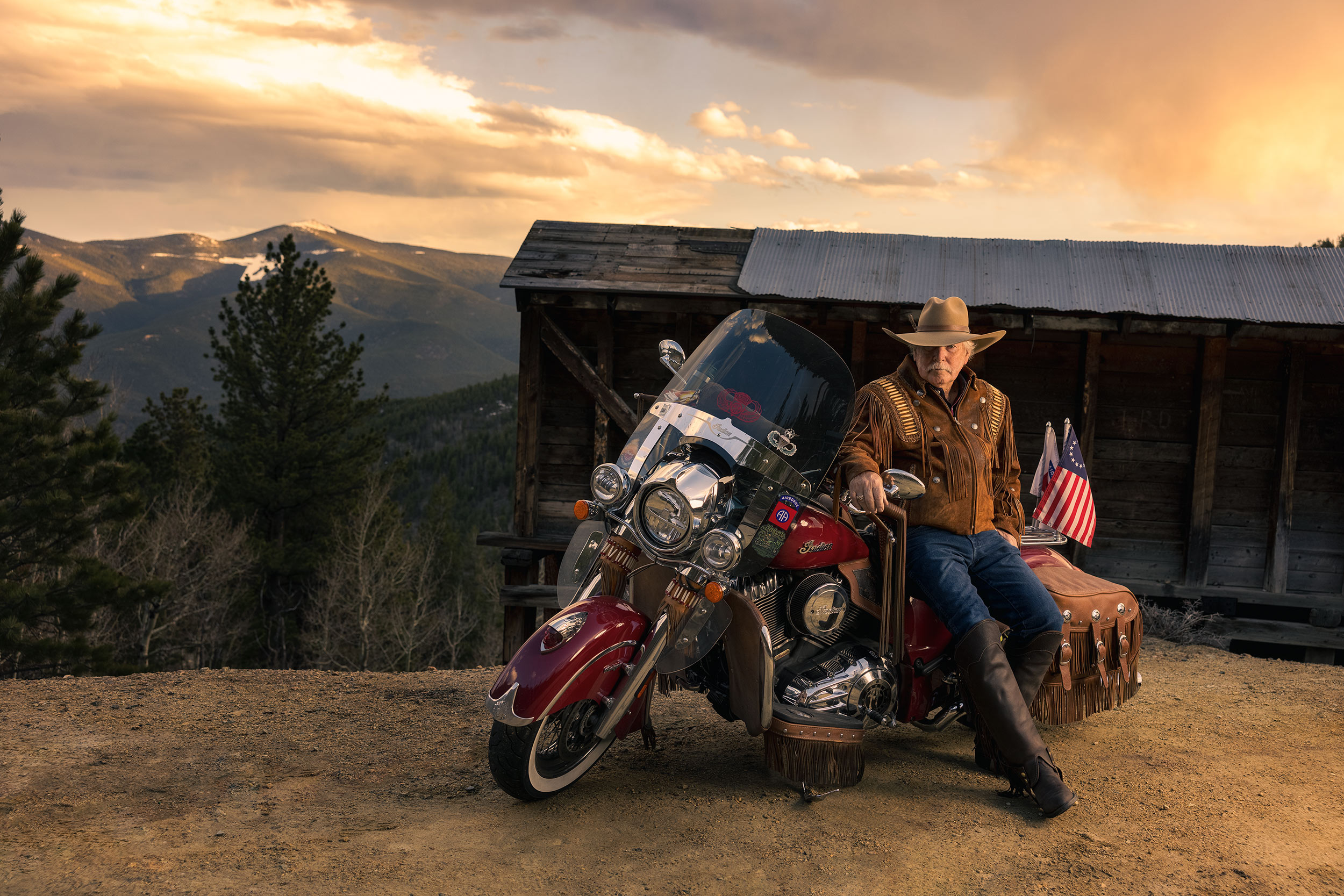 Mature Biker sitting on Indian motorcycle in the mountains