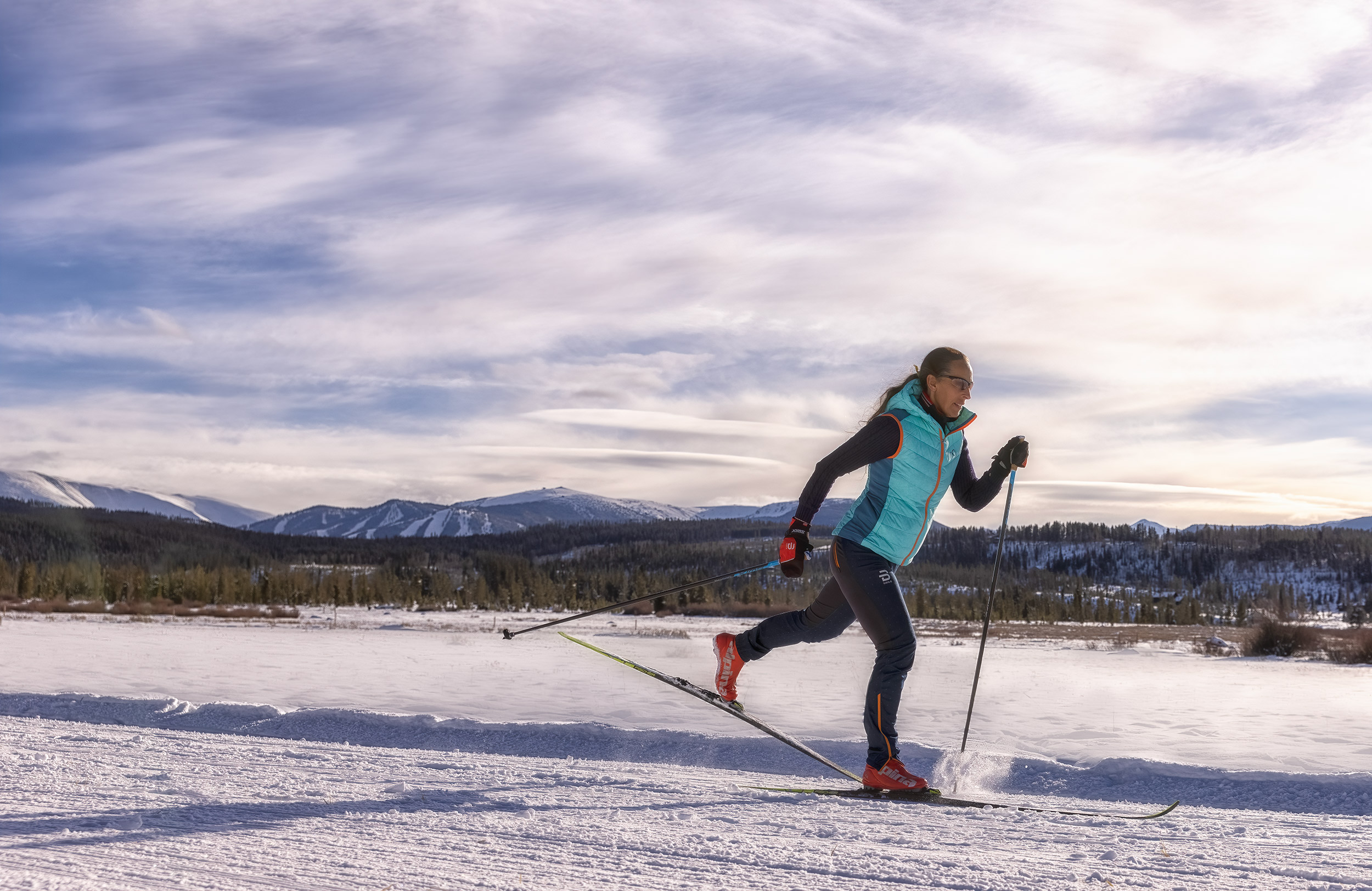 Woman Cross Country Skate Skiing in the Mountains for Devil