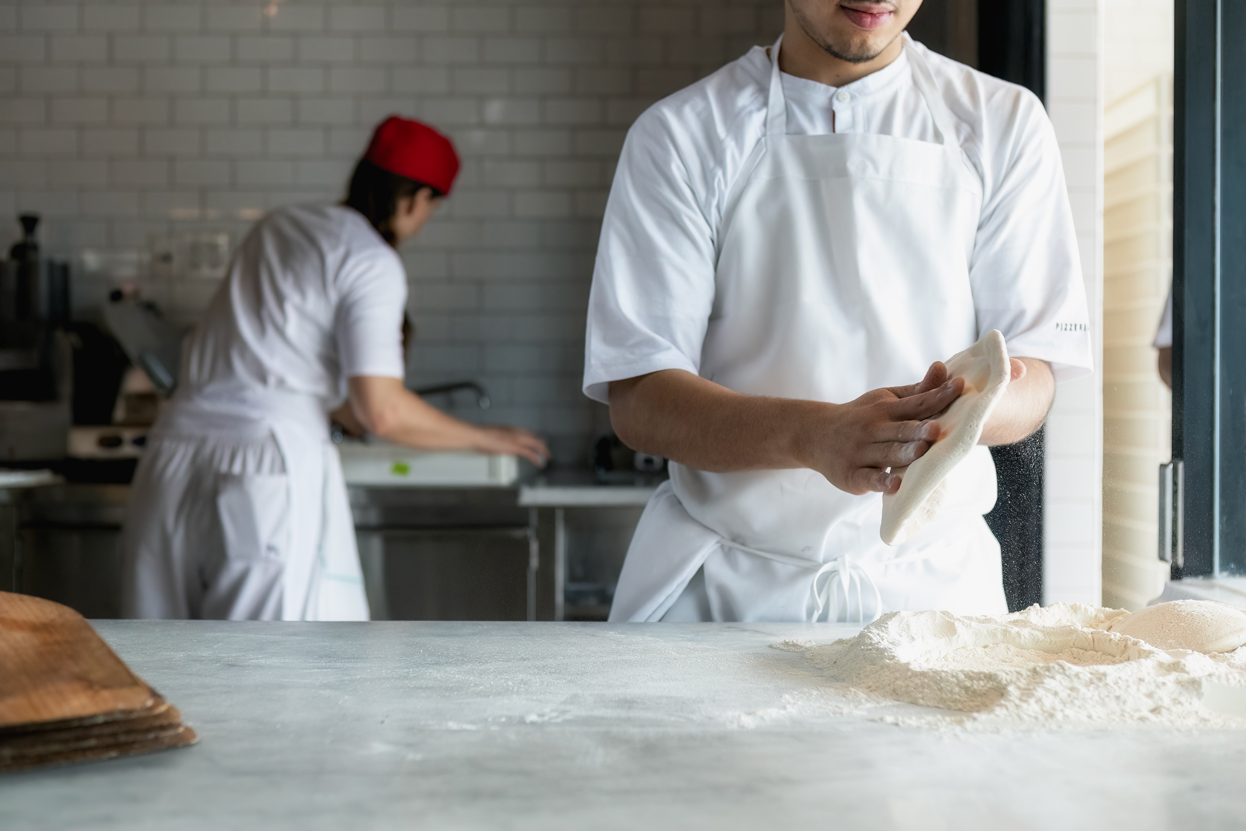 Forming Pizza dough crust for Pizzaria Locale