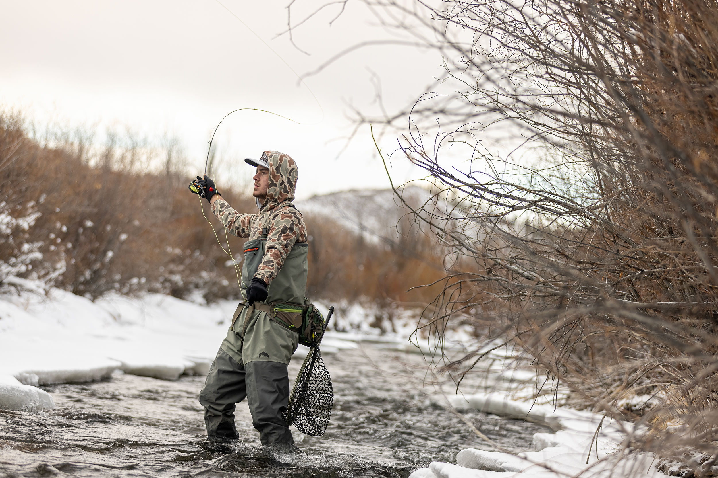 Winter fly fishing in a mountain stream for Devil Thumbs Ranch