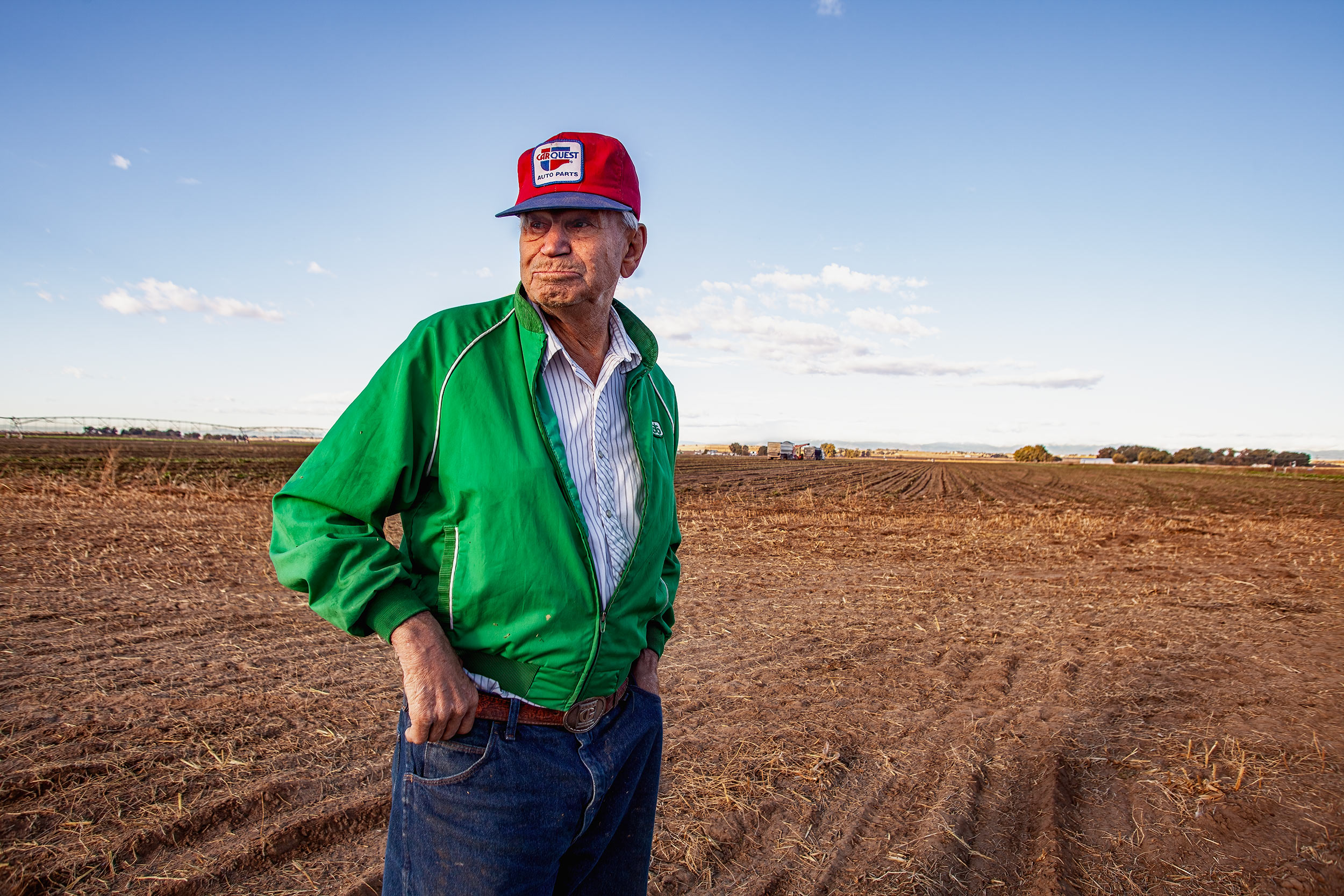 Portrait of a senior farmer standing in a harvested and tilled field.  Agriculture Photography