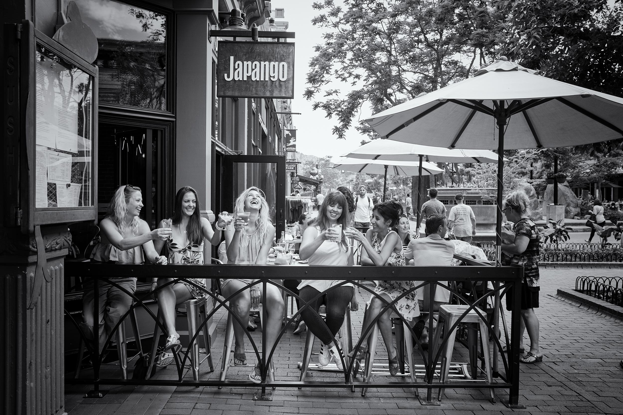 Women enjoying a drink on an outside patio For Japango