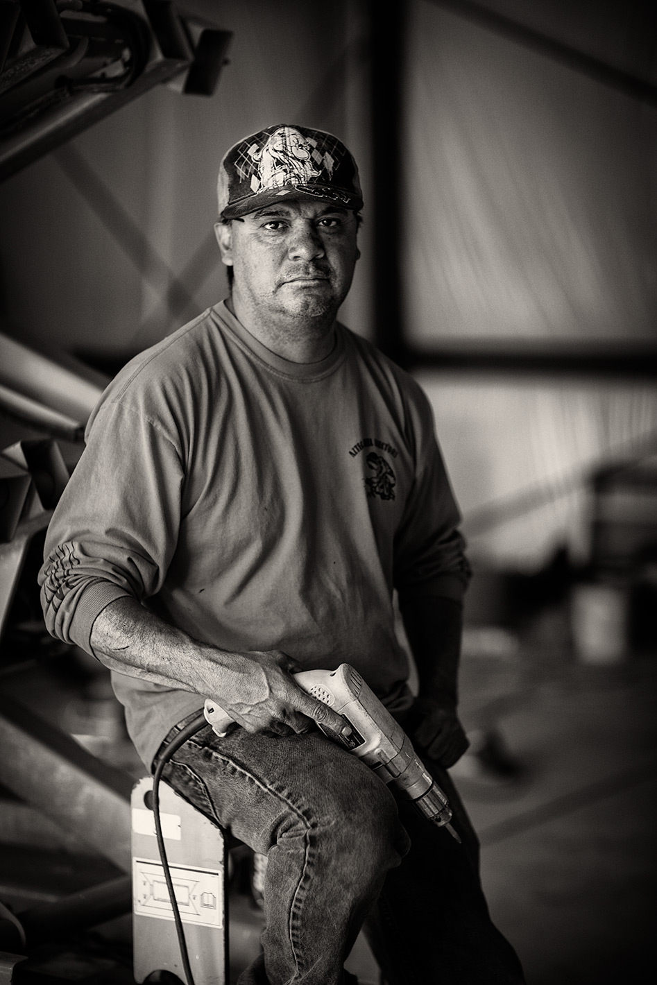 Black and white portrait of construction man with ball cap. 