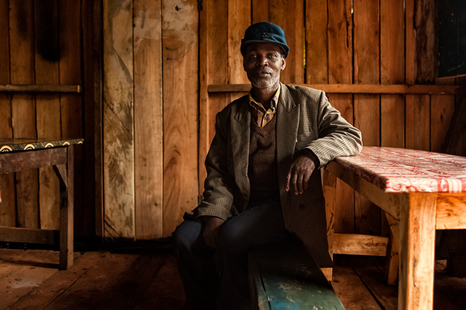 Portrait of coffee farmer by kitchen table. Agriculture photography