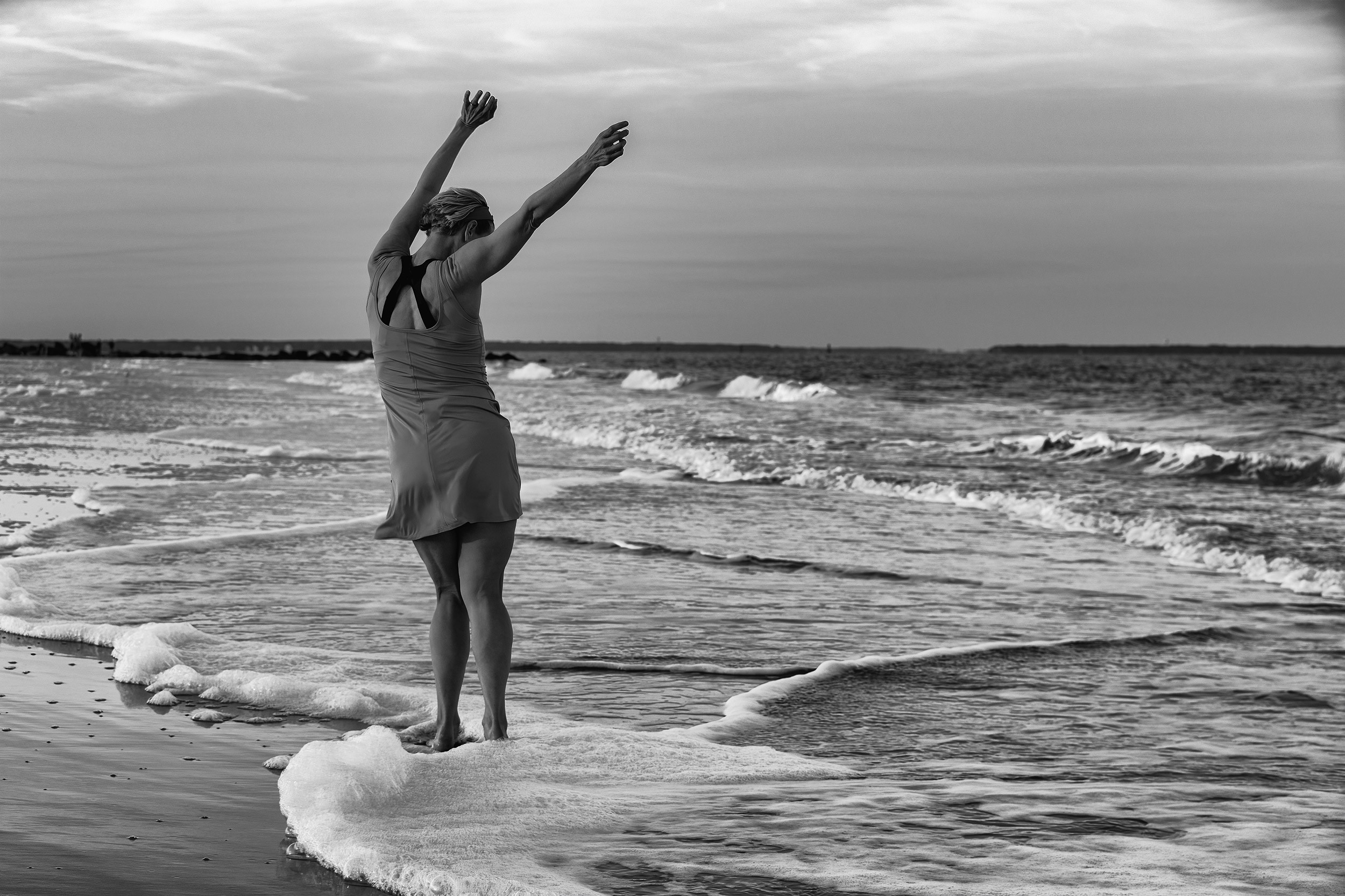 Female model at the beach in the swash dancing