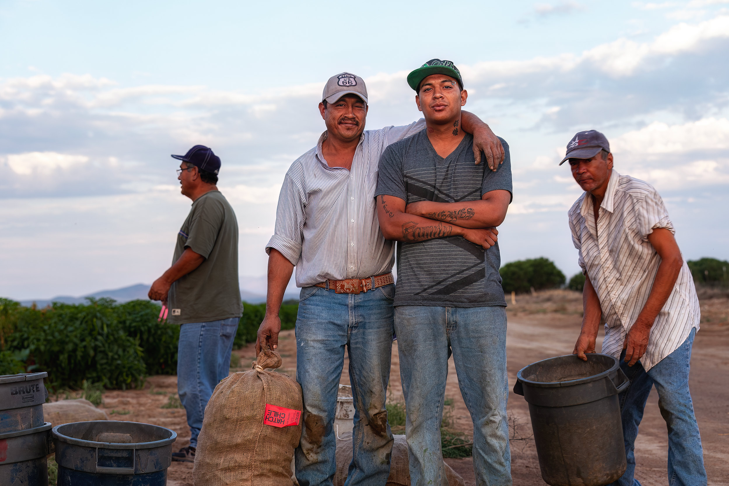 Crop workers posing for a picture at the end of the day in the field after work. agriculture photography c