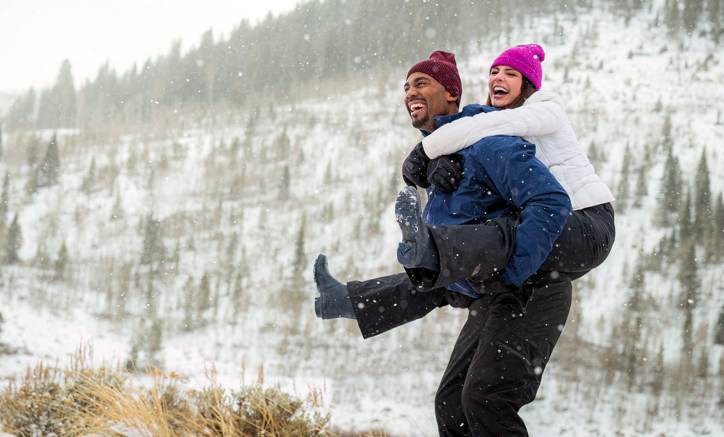 Lifestyle photography of a couple playing in snow for The Travel Channel
