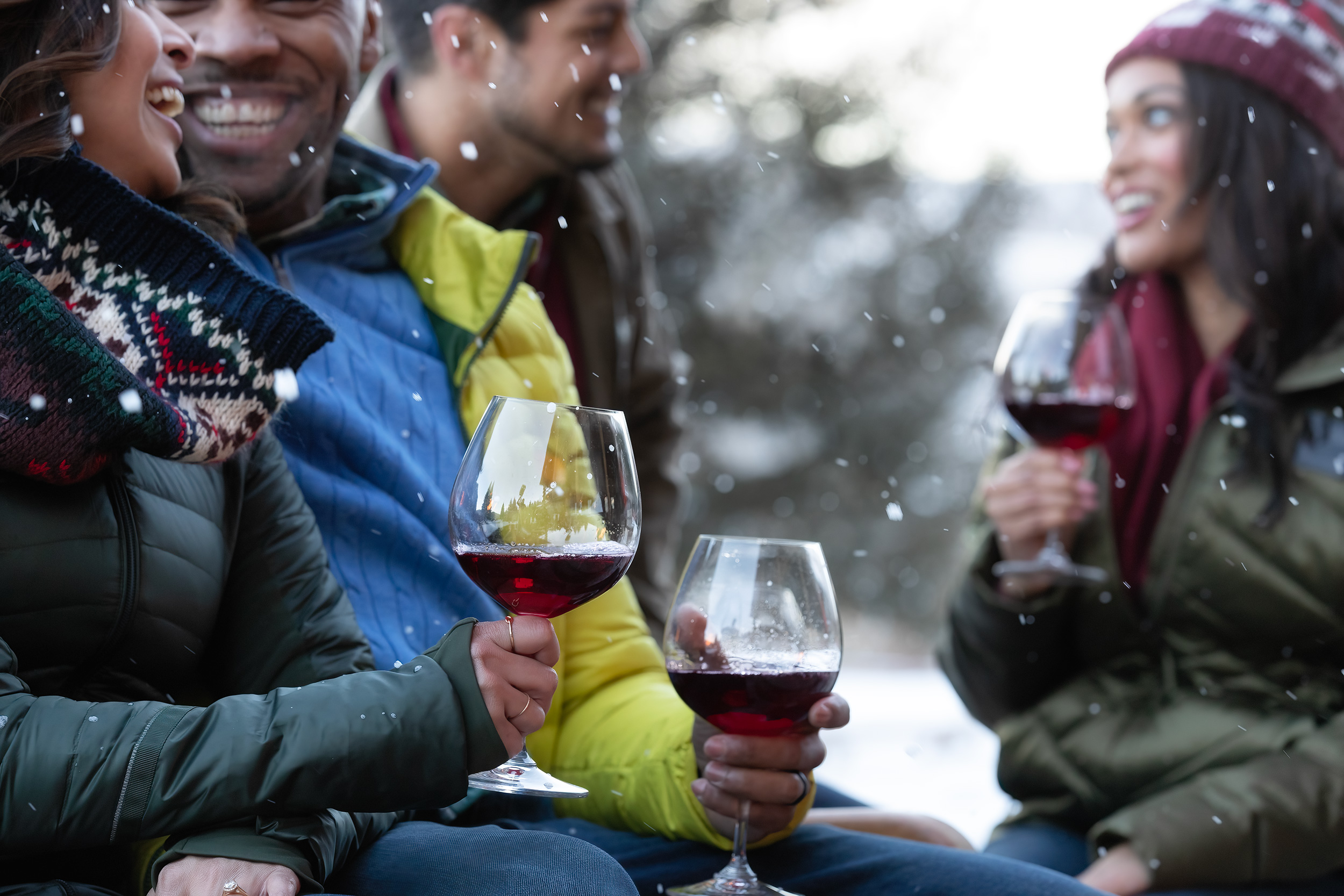 Lifestyle photography, friends outside drinking wine in the snow